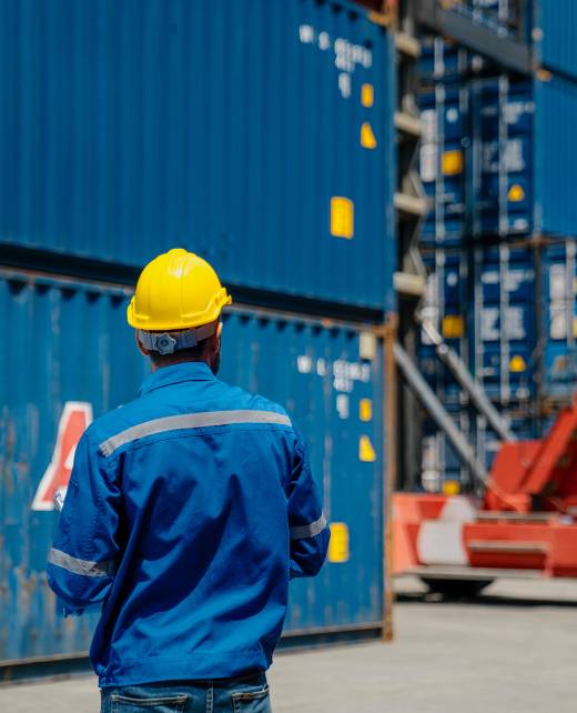 Foreman checking and control loading containers. Working in cargo container warehouse industry factory site in export, import, and transportation concept.